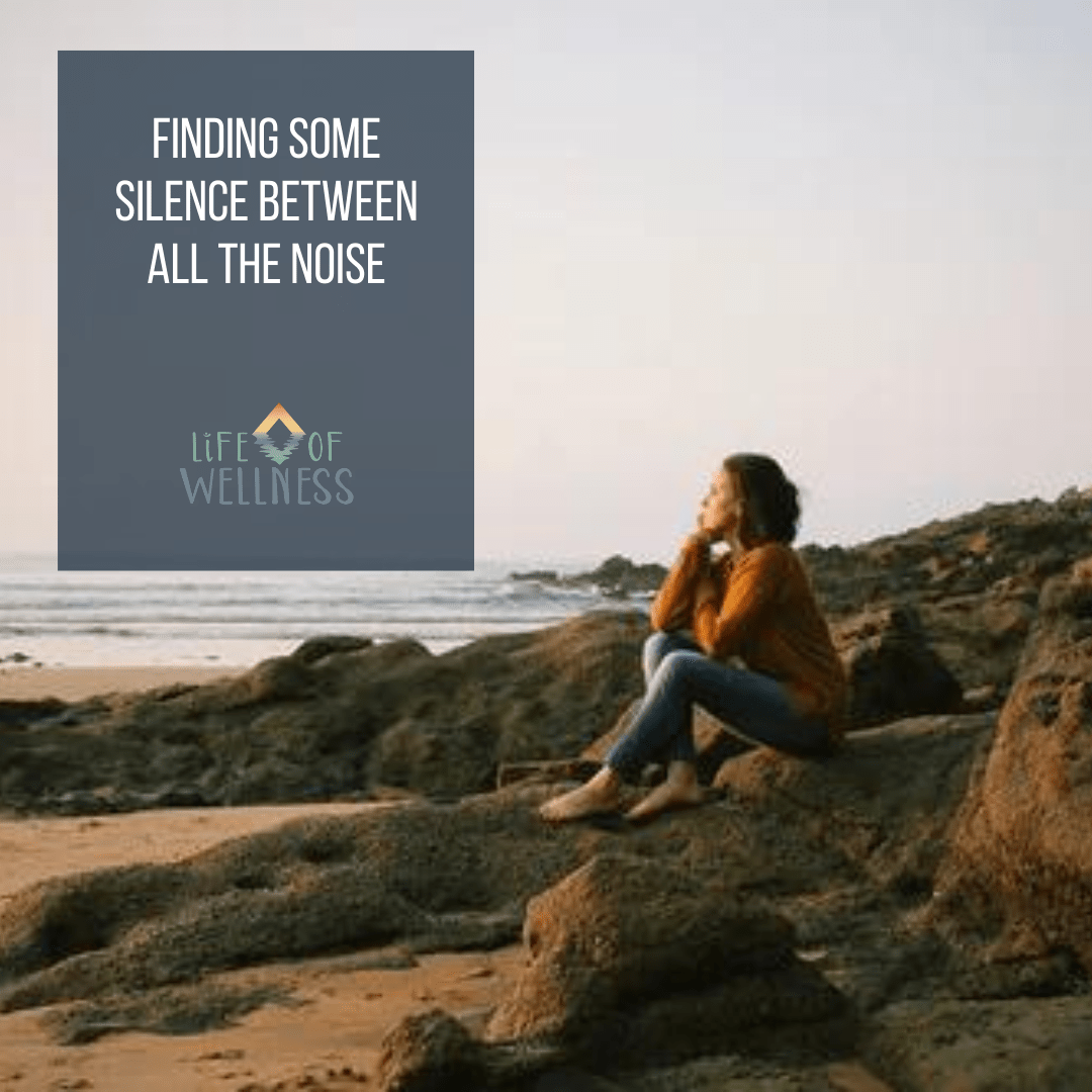 A women sitting on a rock at the beach in silence